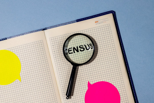 Census word on notepad throught the loupe magnifier