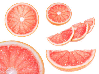 Naklejka na ściany i meble Close up of a sliced fresh grapefruit, Slice of red grapefruit isolated on white background