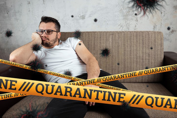 Quarantine Barrier yellow forbidden tape, isolation. Coronavirus. A man sits at home on a self-isolating particle of the COVID-19 virus. The concept is boring.