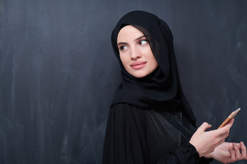 young modern muslim business woman using smartphone