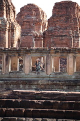 The woman is at the window of the Prasat Mueang Tam (Mueang Tam castle) in Buriram, Thailand