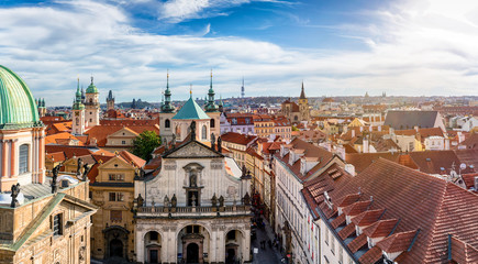 Obraz premium Aerial view over the beautiful, gothic style rooftops of Prague, Czech Republic, on a sunny day