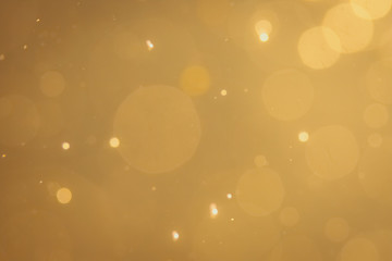 Dark Abstract Gold bokeh sparkle on black background