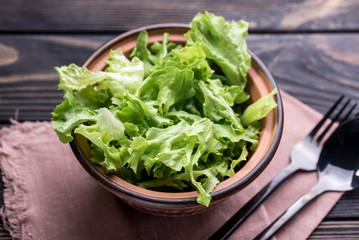 Fresh salad with lettuce and olive oil in a deep piala, on a dining table