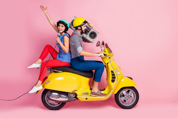 Full length profile side photo crazy cool rock stars two people motorcyclist traveling singers rider drivers ride motor bike man hold boom box woman sing mic isolated pink color background