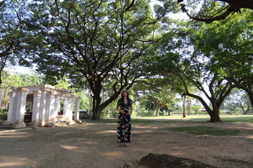 Woman standing under Chamchuri Tree in Buriram, Thailand