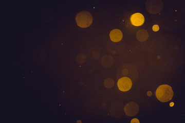 Dark Abstract Gold bokeh sparkle on black background