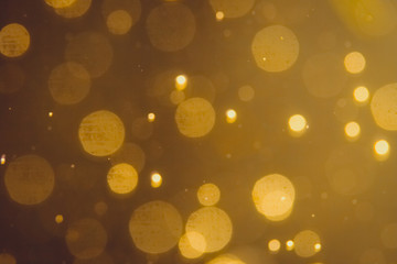 Dark Abstract Gold bokeh sparkle on black background
