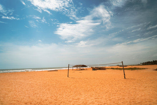 Rajska plaża, błękitne niebo i boisko na siatkówki plażowej.