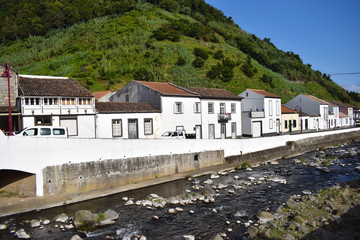 Fototapeta na wymiar Empty streets in Portugal due to coronavirus. Azorean islands, small town with white houses by the river