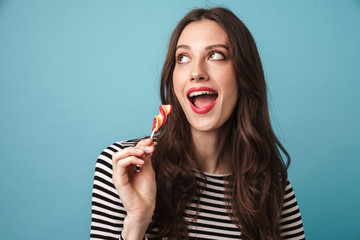 Photo of alluring beautiful woman posing with lollipop