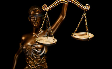 Bronze Themis statue - symbol of Justice - Isolated on black - Focus and light on the scales