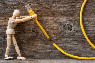 Wooden doll and internet cable