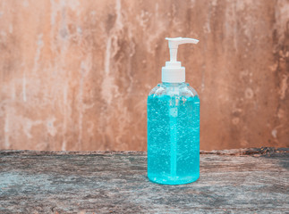 Bottle of hand sanitizer, antimicrobial liquid gel, germ prevention or antibacterial hygiene,on wooden table.