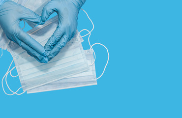 Protective medical white face mask on a blue background. View from above. Space for text. Close up, gorizontal orientation