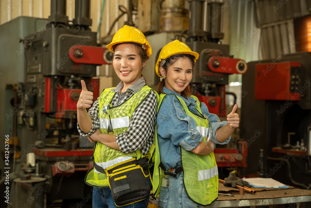 Aufkleber Them engineering working in factory,Happy workers working at the machine working with lathe in industrial building.