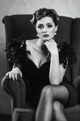 young brunette model girl and actress in a chair, black and white