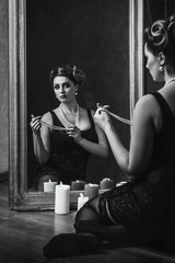 young brunette model girl and actress in front of a mirror, blac