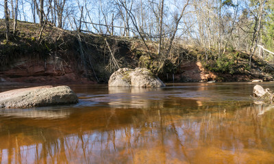 Fototapeta na wymiar Small rivers with stones in long exposure