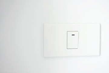 White light switch, a plastic of installed on a wall.  turn on or turn off the lights. Concept save energy.