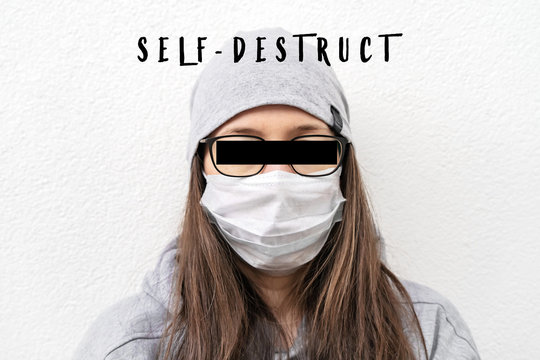 . Young Woman In A Medical Face Mask On A White Background . The Label Self-destruct. The Eyes Are Crossed Out With A Black Line.