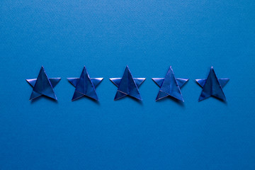 Five stars quality rating on blue background