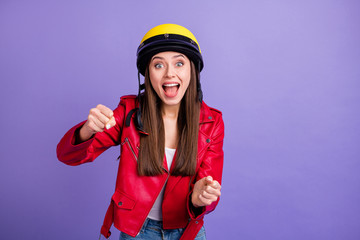 Photo of pretty excited cool lady driver holding imaginary steering wheel wear stylish yellow protective helmet leather jacket white jeans isolated pastel purple color background