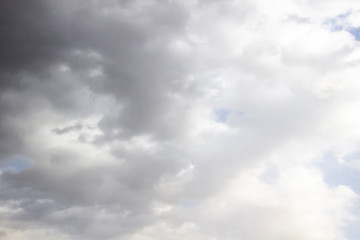 Clouds in the blue sky. A stunning gray sky. The storm is approaching. A beautiful clouds against the blue sky background. Amazing cloud pattern in the sky.