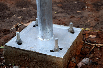 The electric pole base is secured with bolts for strength.