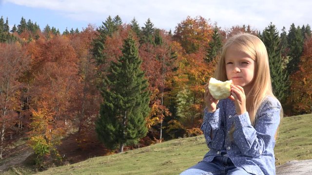 Kid Eating Apple, Child Outdoor in Nature, Little Girl Eats Fresh Fruits