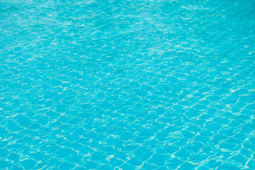 Reflections from the water in the blue swimming pool