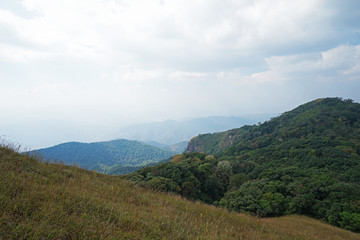 Natural landscape of green mountain range with cloudy blue sky