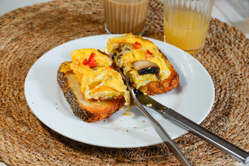 Mushroom and red pepper omelette on toast with ginger shot and coffee.