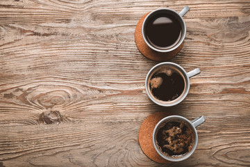 Obraz na płótnie Canvas Cups of coffee on wooden background