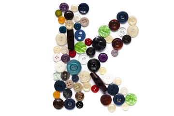 Letter K design made from clothing elements.