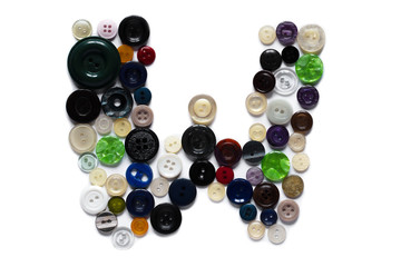 Letter W design made from clothing elements.