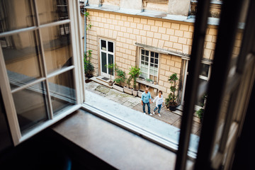 guy and a girl happily walk in the morning on the empty streets