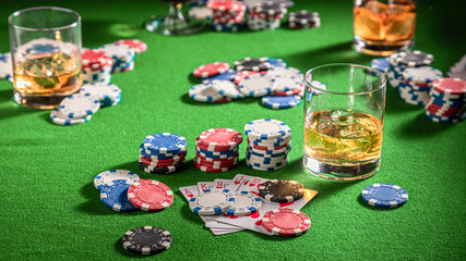 Cards and chips on green gambling table