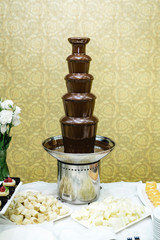 chocolate fountain hot liquid flowing down tower pyramid