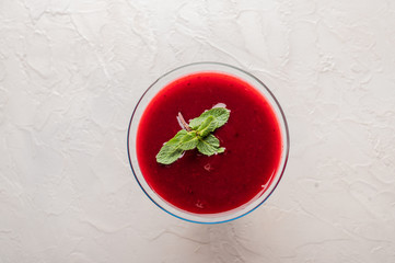 Russian national drink cranberry jelly with mint on a light background top view. Organic food
