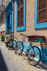 Fototapeta na wymiar Greece Rhodes, 11/07/2018 : Walk around the old town. Bicycles against the wall with beautiful styling.