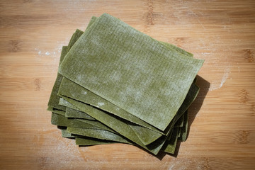 Stack of lasagna layers handmade with spinach