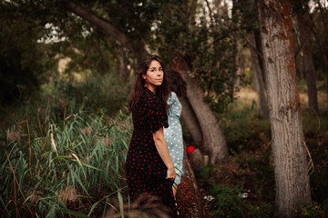 Back view of two young women walking through the field