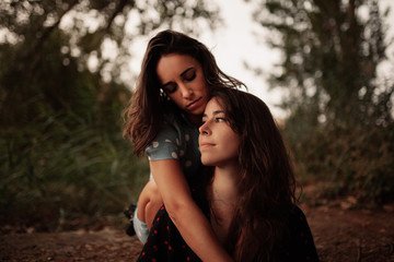 Fototapeta premium Two young women embraced on the field
