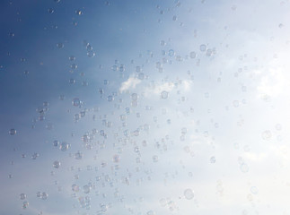 Soap bubbles fly in the blue sky