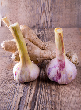 garlic, green, young, ginger on a wooden background