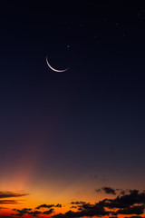 crescent moon and stars on dark sky vertical