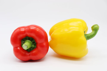 red and yellow peppers on white background