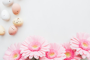 Chocolate Easter eggs and pink gerbera flowers flatlay