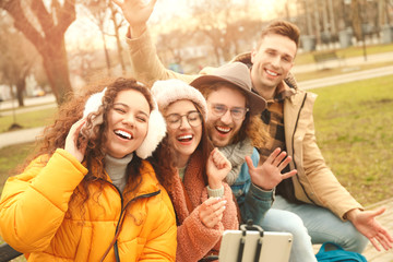 Happy friends taking selfie outdoors